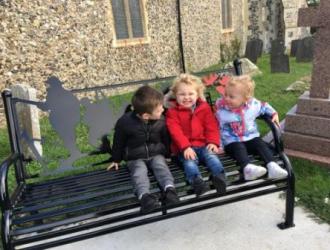 Pre school Children on WWI memorial bench at church